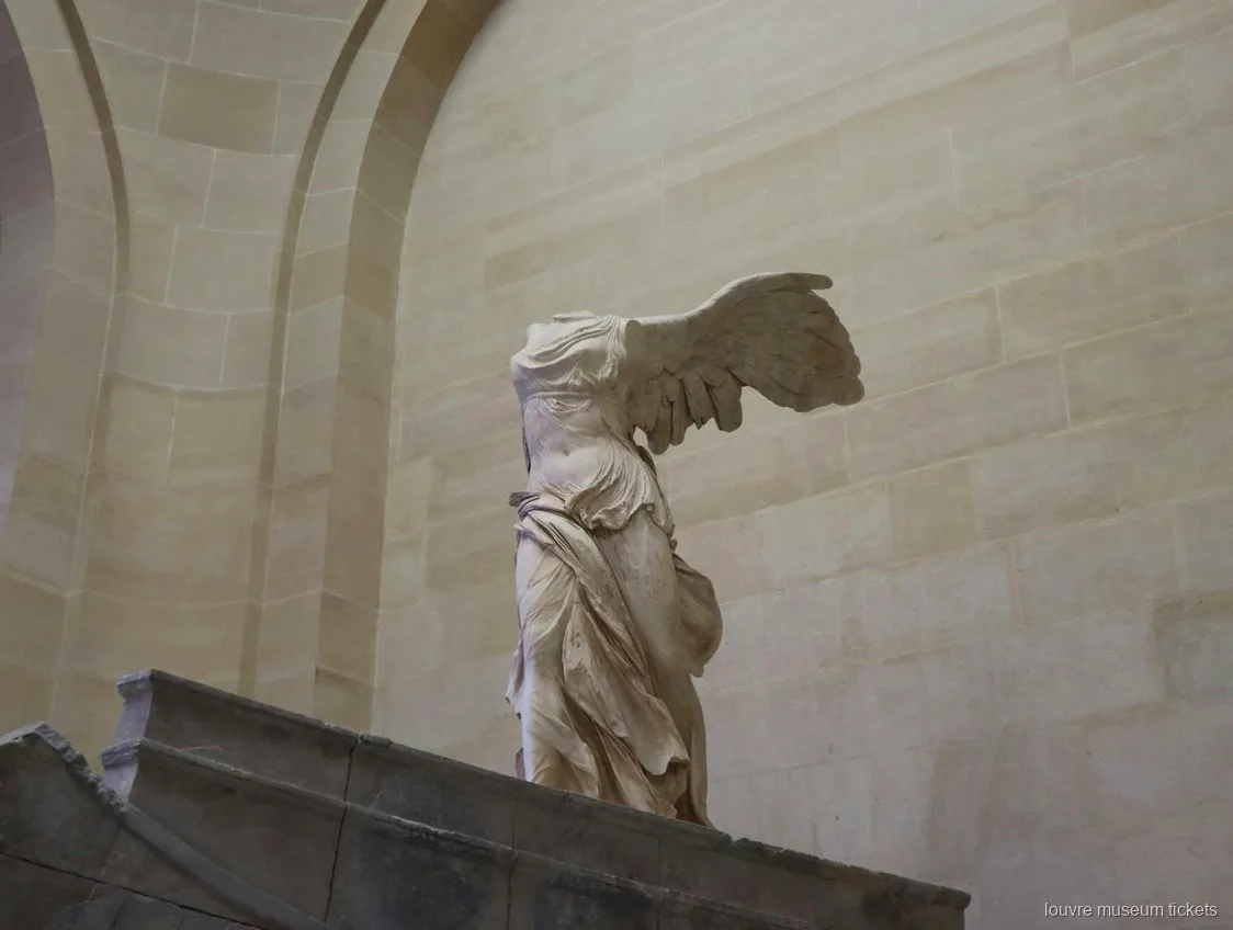 Winged Victory of Samothrace on its stone ship prow base, a highlight of the family tour with Louvre Museum tickets